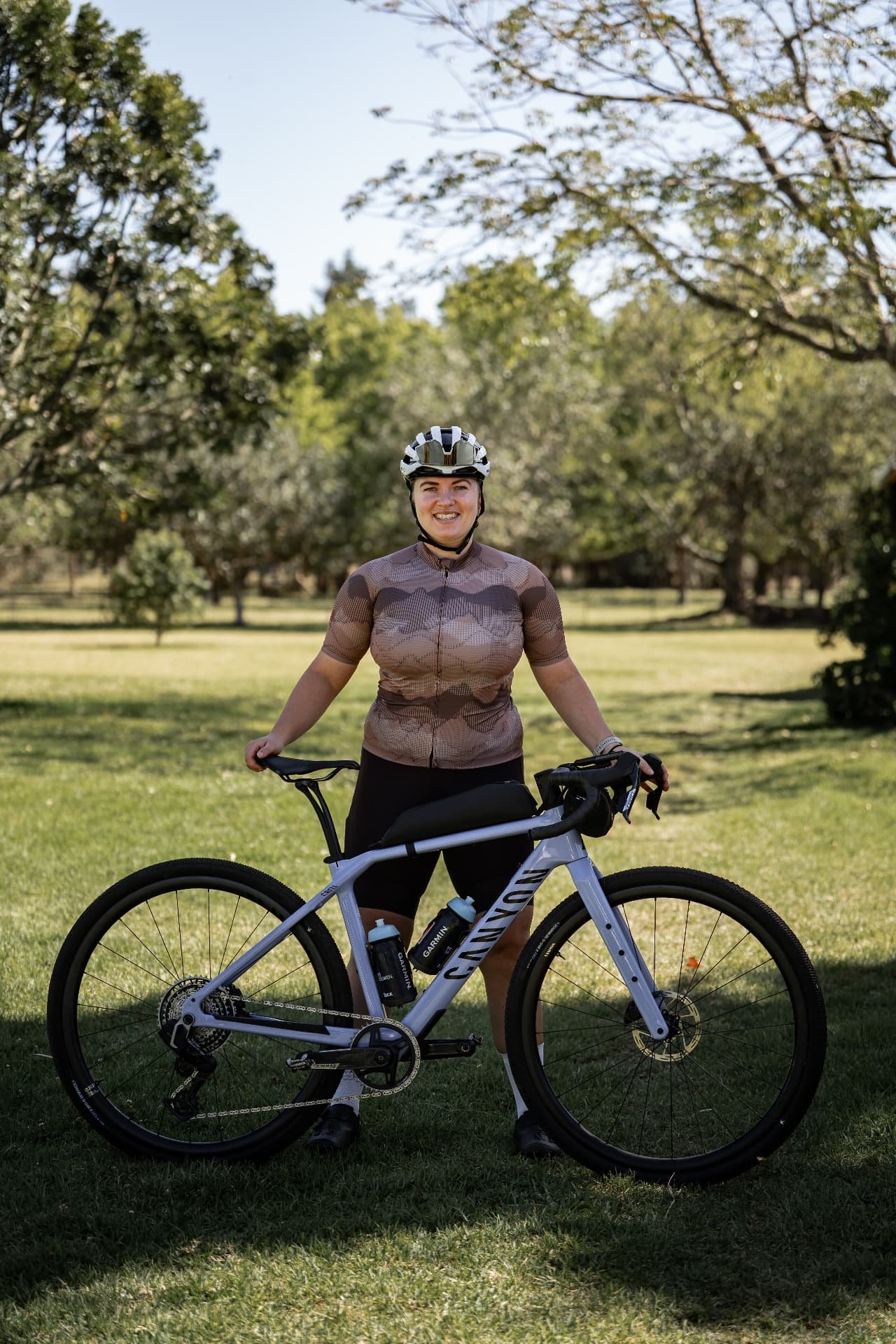 Cycling woman with her gravel bike in a green environment
