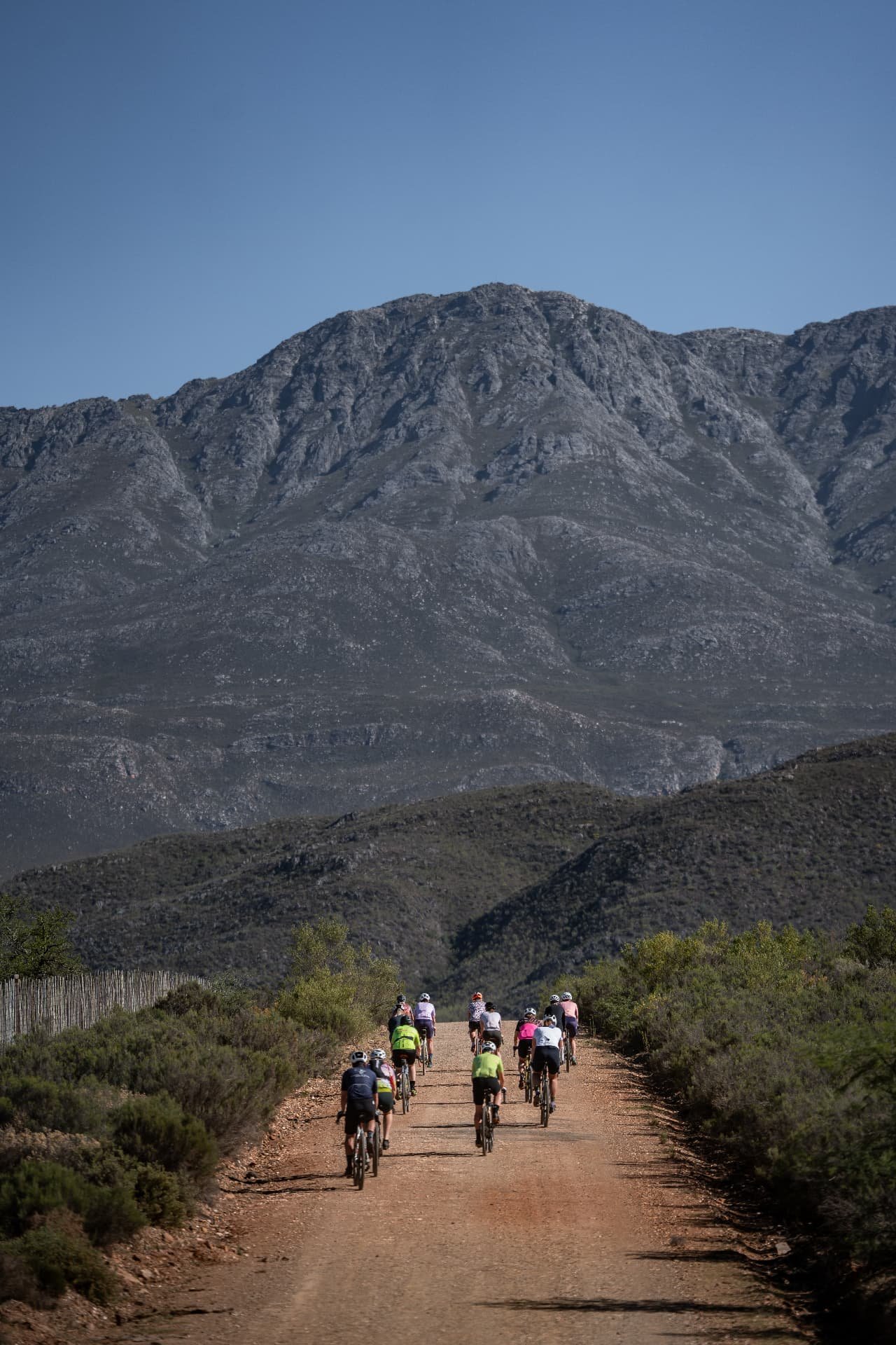 Group of Cyclingwomen together on a gravel road towards the mountains in South Africa
